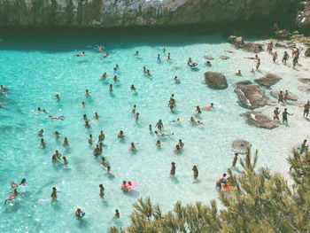 High angle view of people swimming in sea