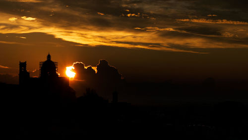 Silhouette building against sky during sunset