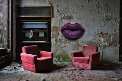 Close-up of damaged chair in abandoned house