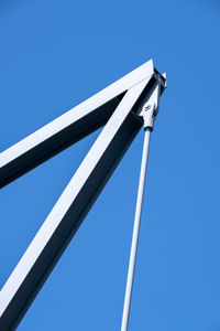 Low angle view of pole against clear blue sky