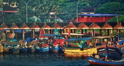 Boats moored in river against sky