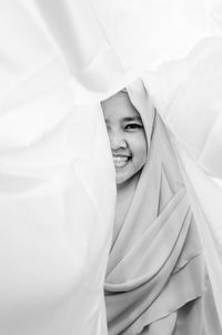 Portrait of smiling girl in headscarf