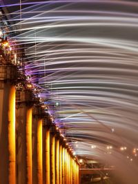 Illuminated bridge against sky at night