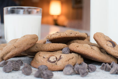 Close-up of cookies by milk glass