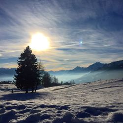 Scenic view of snow covered landscape against sky