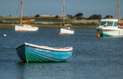 Boats moored on sea against sky