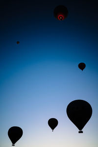 Low angle view of hot air balloons against sky