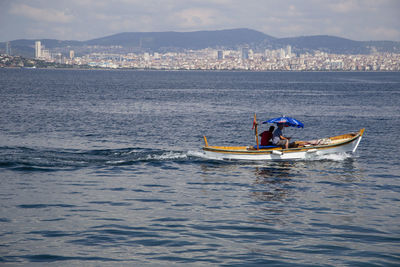 Man in sea against sky