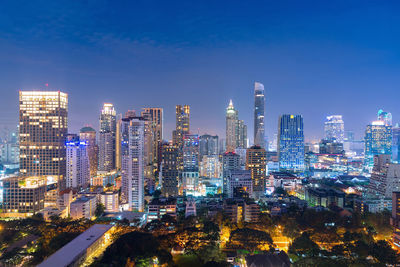 Aerial view of city lit up at night