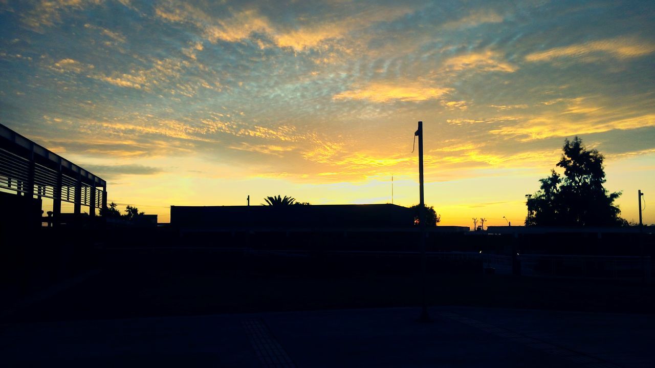 SILHOUETTE OF BUILT STRUCTURE AT SUNSET