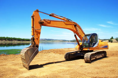 Construction site on beach against sky