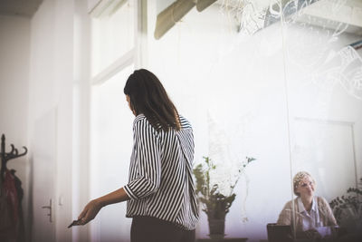 Woman standing against wall