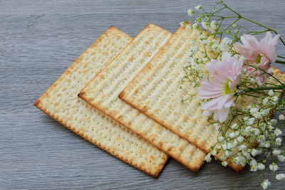 High angle view of flowers with crackers on table