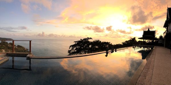 Scenic view of swimming pool against sky during sunset