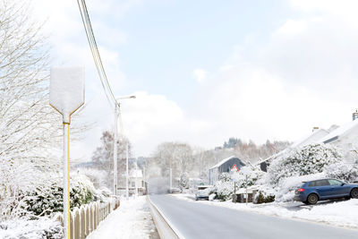 Snow covered road against sky