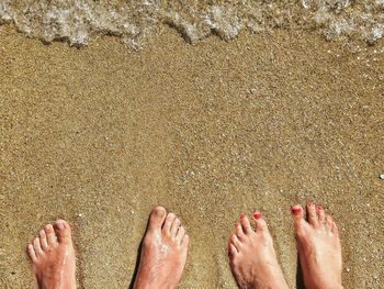 Low section of woman standing on beach