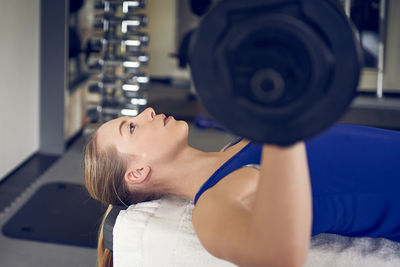 Young woman exercising at gym