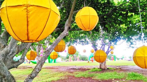 Low angle view of yellow lantern against sky