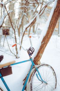 Old antique bike covered with snow in winter time