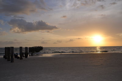 View of calm beach at sunset