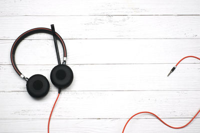 Directly above shot of electric lamp on table against white wall
