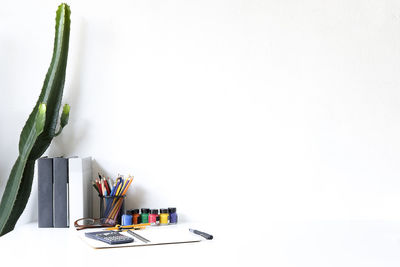 Close-up of pencils on table against white background