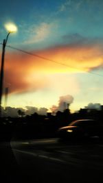 Cars on road at sunset