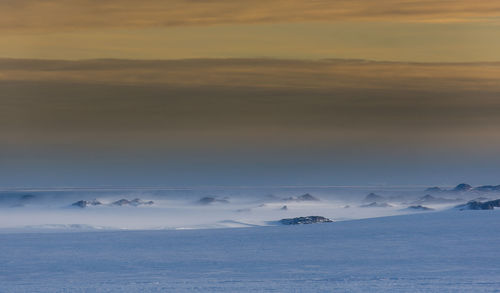 Scenic view of snowcapped mountain against sky during sunset