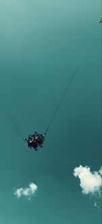 Low angle view of rope in sea against sky