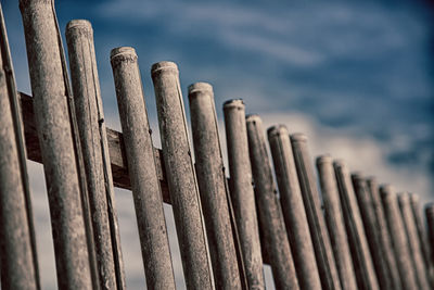 Close-up of wooden fence against sky