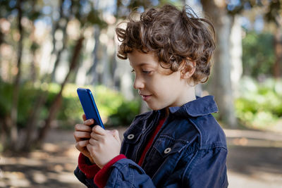 Boy holding mobile phone