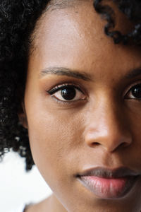 Portrait of a beautiful black woman with curly hair on a white background