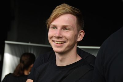 Close-up of smiling young man looking away