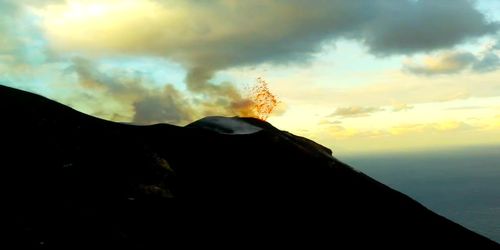 Scenic view of silhouette mountain against sky during sunset