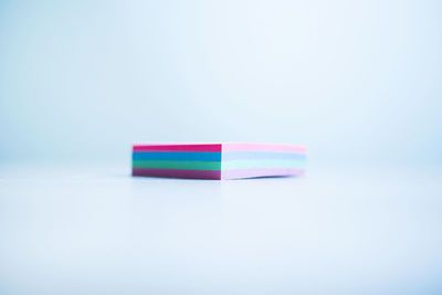 Close-up of colored pencils over white background