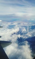 Cropped image of airplane wing over landscape