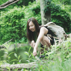 Portrait of young woman sitting on field