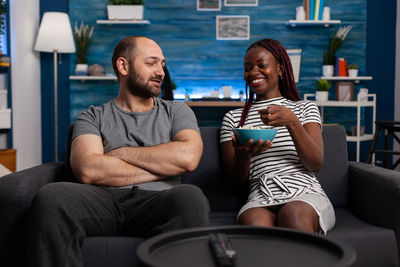 Young couple sitting on wall