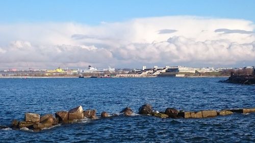 River in city against cloudy sky