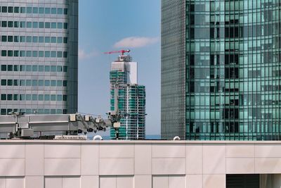 Low angle view of modern buildings in city against sky