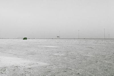 Man on snow covered landscape against clear sky