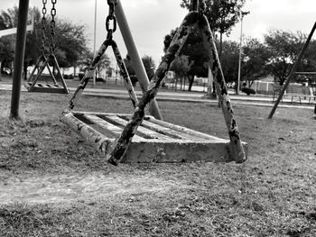 Empty swing on grassy field