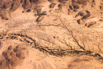 High angle view of footprints on sand at beach