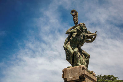 Low angle view of statue against sky