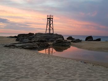 Scenic view of beach against sky during sunset