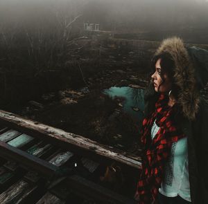 Woman standing on railway tracks