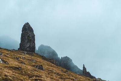 Low angle view of rock formations against sky