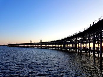 Bridge over river against clear sky