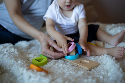 Midsection of woman playing with toy blocks at home