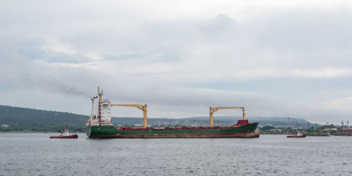 Ship sailing in sea against sky